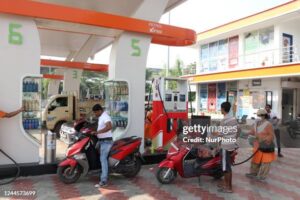 a-petroleum-pump-women-staff-puts-a-fuel-nozzle-into-a-two-wheeler-in-kolkata-india-06